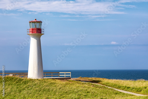 Borgot  or Cape Herisse lighthouse of Cap aux Meules  Magdalen Islands  Canada. The lighthouse stands on the rugged red cliffs of the Etang du Nord.