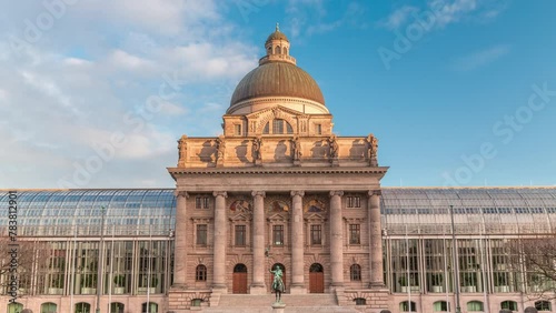 View of Bayerische Staatskanzlei timelapse during sunset, Bavarian State Chancellery building (the former Bayerische Armeemuseum, Bavarian Army museum). Monument in front of entrance. Munich, Germany photo