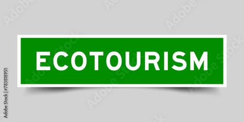 Green color square label sticker with word ecotourism that inserted in gray background