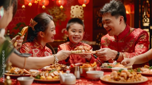 Family enjoying New Year s dinner in red  Chinese text on reunion dinner