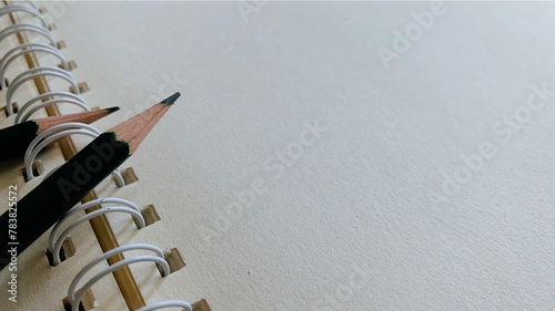 Pencil and notebook lying on desk