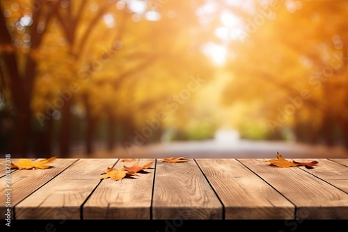 Wooden Table Perspective with Autumn Leaves and Blurred Background © KirKam