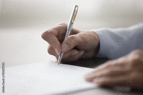 Unknown female hand holding pen and signing legal contract agreement, buying or selling services, make profitable business transaction, put signature of testament, affirming document. Successful deal