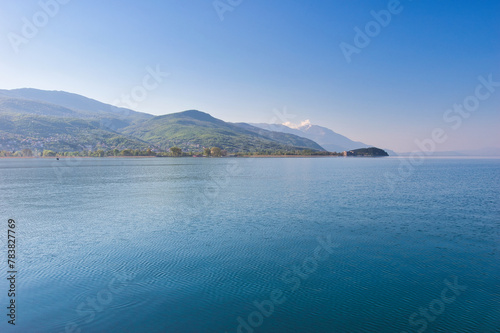 Lake Ohrid, North Macedonia, April 13 2024. Mountain range and peninsula in distance. Ohrid Lake, Macedonia, Europe. The clear mesmerizing waters of lake Ohrid with a beautiful view. 