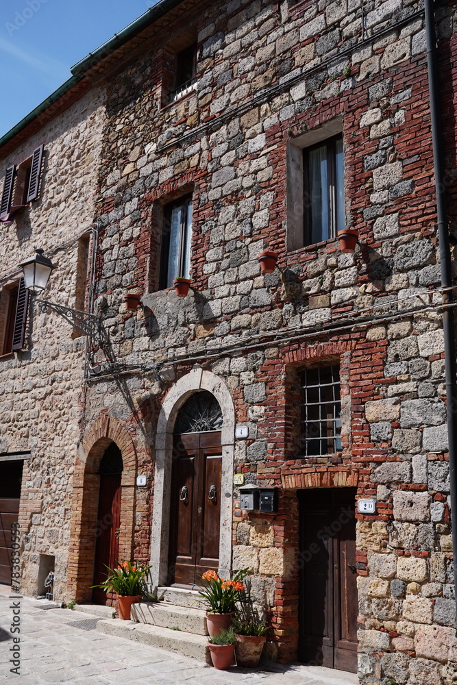 Chiusdino, Siena, Tuscany, Italy - Typical tuscan historical town with narrow street and terracotta bricks.