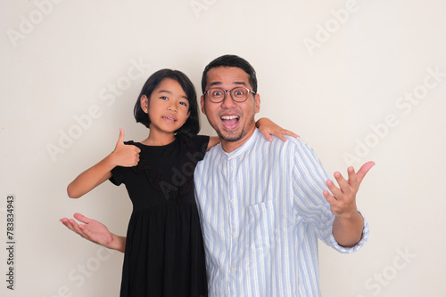 An Asian father and his daughter showing happy face expression photo