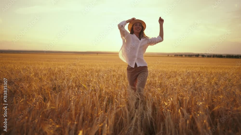 Romantic carefree happy woman running on yellow wheat field with spreading flying arms enjoying freedom calmness on rural nature during vacations holidays. Rest, relax in country, activity at sunset. Romantic carefree happy woman running on yellow wheat field with spreading flying arms enjoying freedom calmness on rural nature during vacations holidays. Rest, relax in country, activity at sunset.