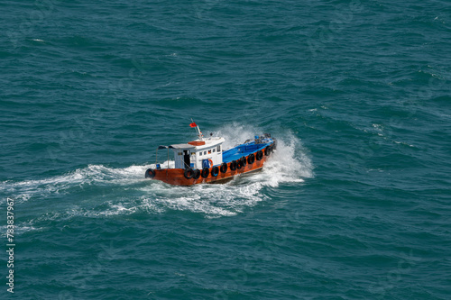The Asian boat of the pilot in the high sea during a storm.