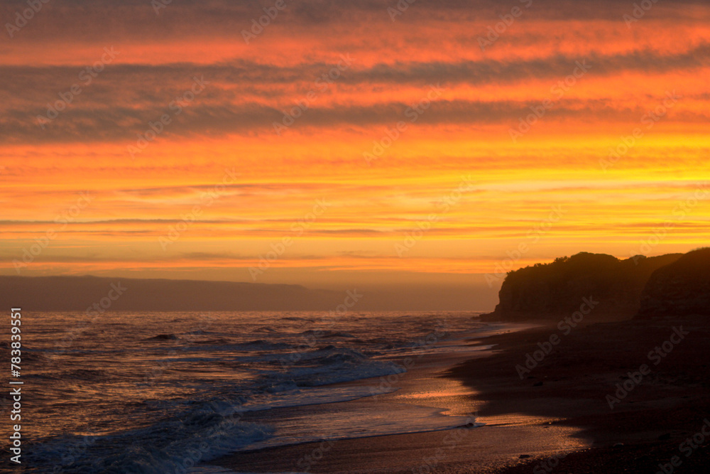 Golden Horizon: An Orange Sunset at the Beach