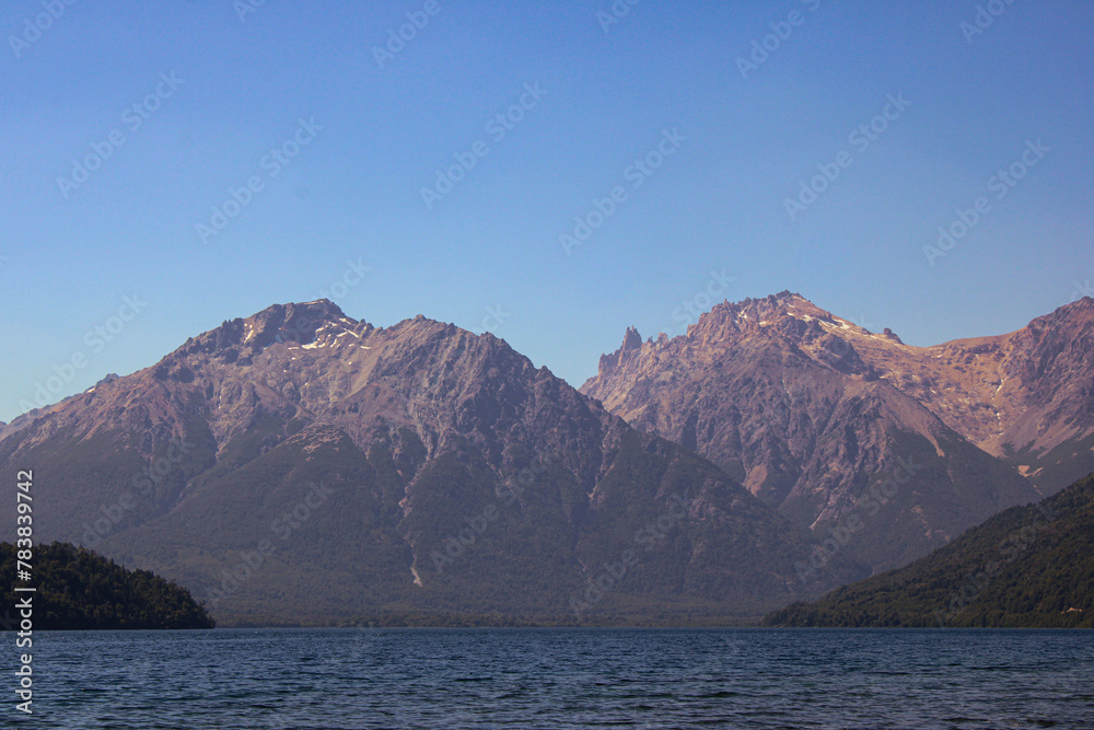 Majestic Mountains Protecting The Calm Waters Of The Lake