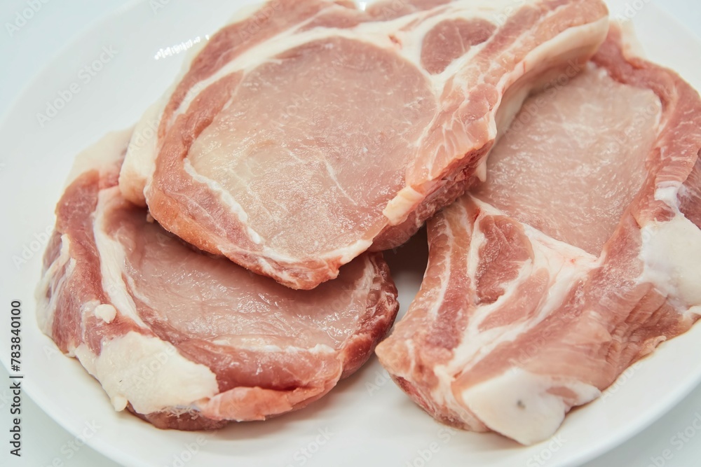 Raw meat on a white background. Pork, beef or lamb. Steak or tenderloin. Different parts of meat products for different dishes. Raw meat on a white background. Pork, beef or lamb. Steak or tenderloin. Different parts of meat products for different dishes.