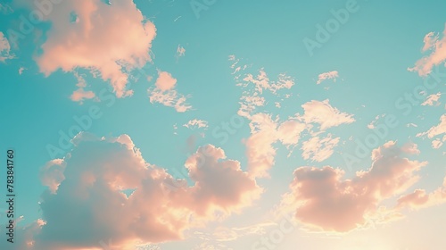 A serene image of a sunset on a blue sky scattered with a few clouds