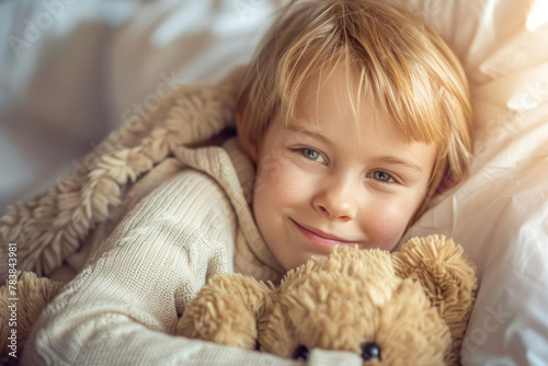 Smiling Child Cuddling with Teddy Bear in Cozy Bed