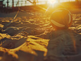 Close-up of a beach volleyball in the sand at sunset, with the warm light casting long shadows