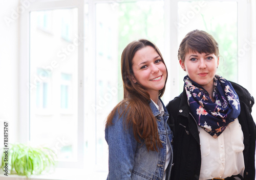 Two female students near the window in classroom