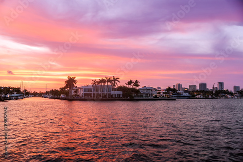 Fort Lauderdale, Florida - March 23, 2024: Mansions and luxury yachts at sunset along the canals of Fort Lauderdale, Florida  © Torval Mork