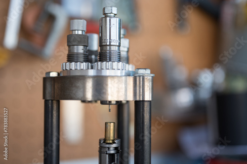 Detail of the decapping and resizing process of a 9mm case in the reloading press. To recover its original size and remove the worn primer and replace it with a new one