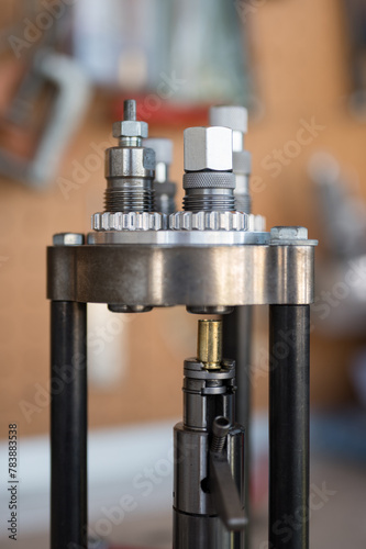 Detail of the Belling or Expanding process of a 9mm case in the reloading press with the expanding die to be able to put the projectile