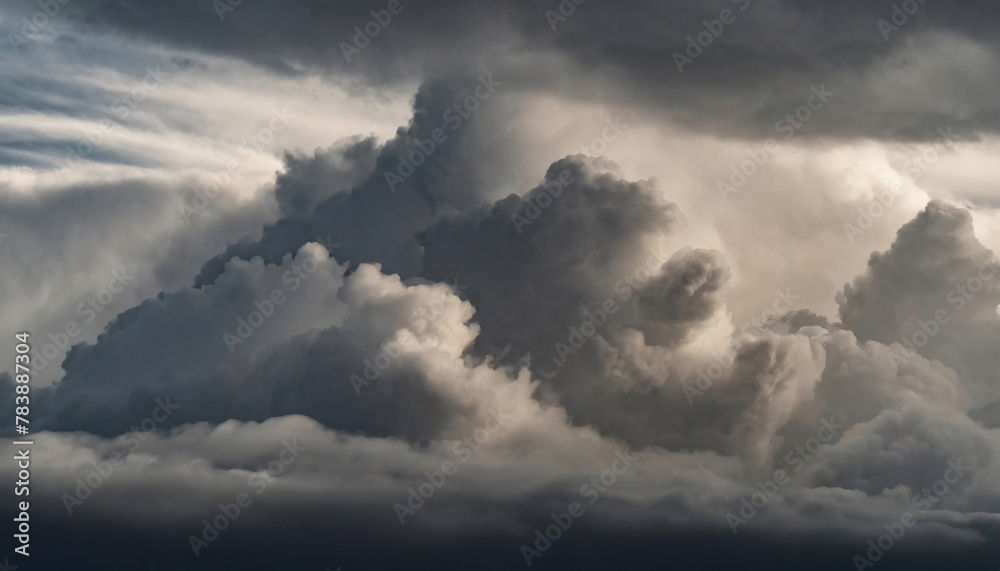 Dramatic cloudscape with dark, billowing clouds illuminated by soft light.