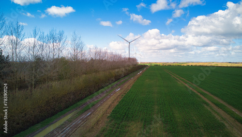 Turbine Windmills wind farm in rural England. Renewable energy. Beautiful sunny day. 