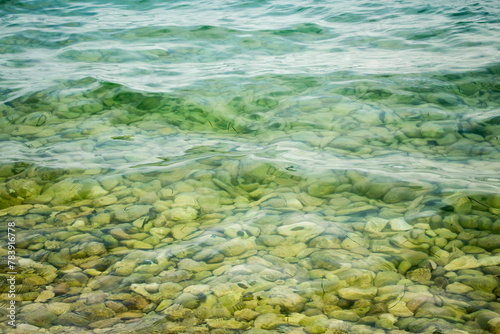 Stones in the sea near the shore under clear water