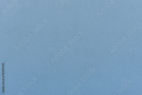 medium blue painted wall with grainy structure