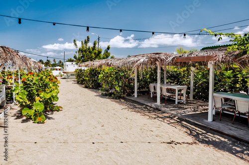 Charlestown, St Kitts and Nevis - March 28, 2028: Beach chairs, palapas and hammocks outside of the port town of Charlestown in Saint Kitts and Nevis
 photo