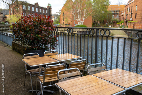 Outdoor tables and chairs beside the River Wensum