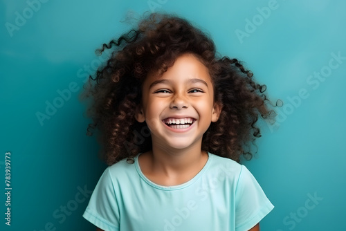 Cute little girl smiling and looking at screen photo