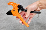 Ratchet type pipe cutter, one hand fast pipes cutting tool on gray background.
