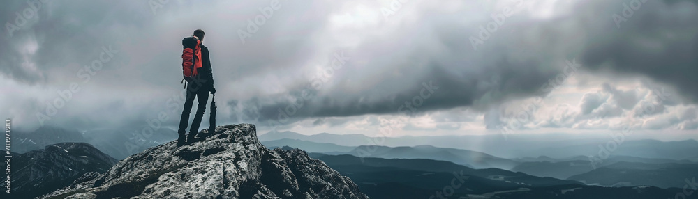 Lone traveler at mountain peak, vast cloudy sky, cool tones, panoramic angle Lone traveler at mountain peak, vast cloudy sky, cool tones, panoramic angle