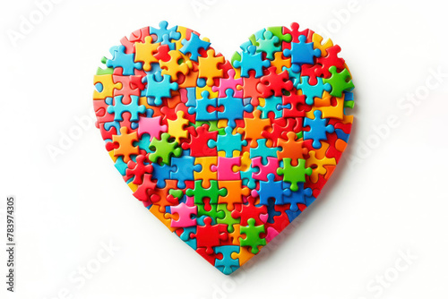 Colorful jigsaw puzzle pieces coming together to form heart on a white background