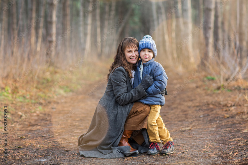Happy mother and son in autumn forest Happy mother and son in autumn forest