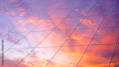 Fototapeta Naklejka Na Ścianę i Meble -  Web banner Modern glass architecture with reflection of red and blue sunset sky. Dramatic bright color. Vintage style background.