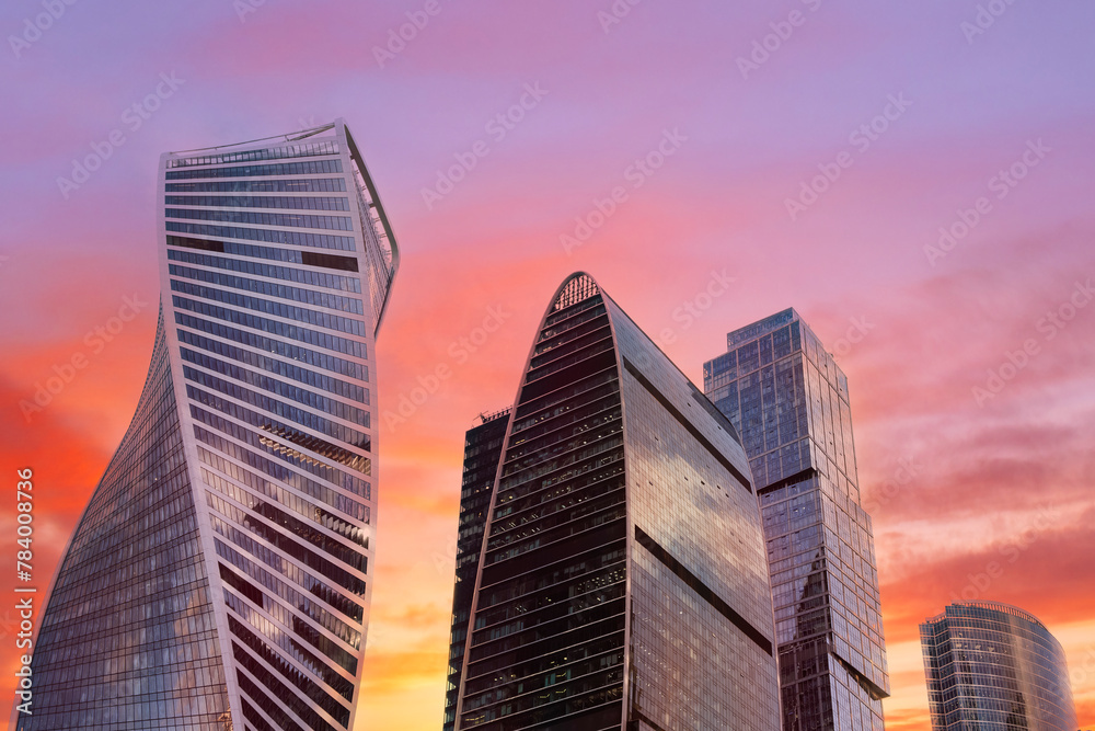 A city skyline with a beautiful sunset in the background. The buildings are tall and shiny, and the sky is a mix of orange and pink hues. Concept of awe and wonder at the beauty of the cityscape A city skyline with a beautiful sunset in the background. The buildings are tall and shiny, and the sky is a mix of orange and pink hues. Concept of awe and wonder at the beauty of the cityscape