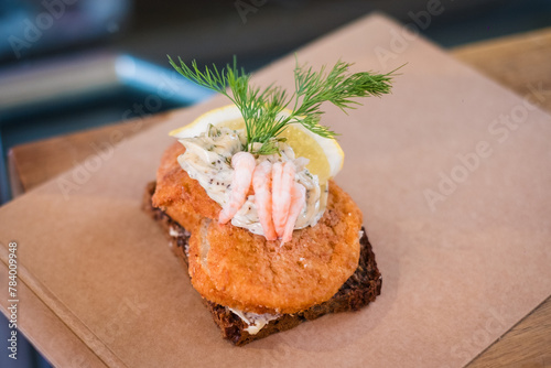 Fish cake gourmet sandwich with shrimp. Traditional open-faced sandwich in cuisines of Denmark (Smørrebrød), Norway (smørbrød) and Sweden (smörgås). 