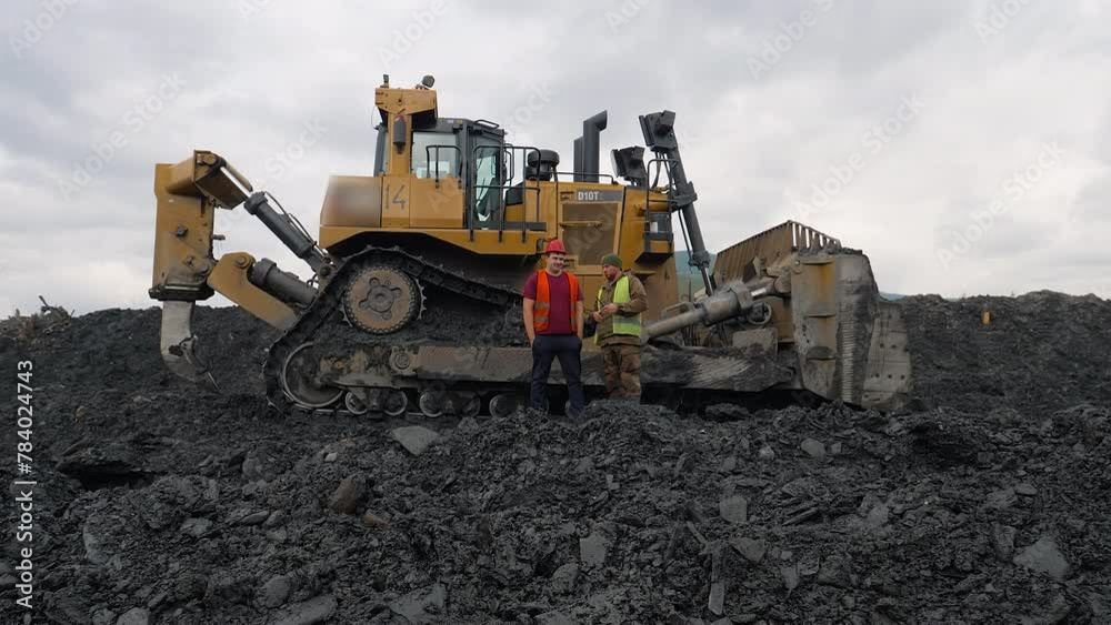 Workers In Vests Discuss Gold Mining Process Near Heavy Bulldozer Equipment. Mining Equipment Operator Worker Talks To Colleague. Land Surveyor Worker Speaks To Mining Equipment Driver. Dirt. Quarry Workers In Vests Discuss Gold Mining Process Near Heavy Bulldozer Equipment. Mining Equipment Operator Worker Talks To Colleague. Land Surveyor Worker Speaks To Mining Equipment Driver. Dirt. Quarry