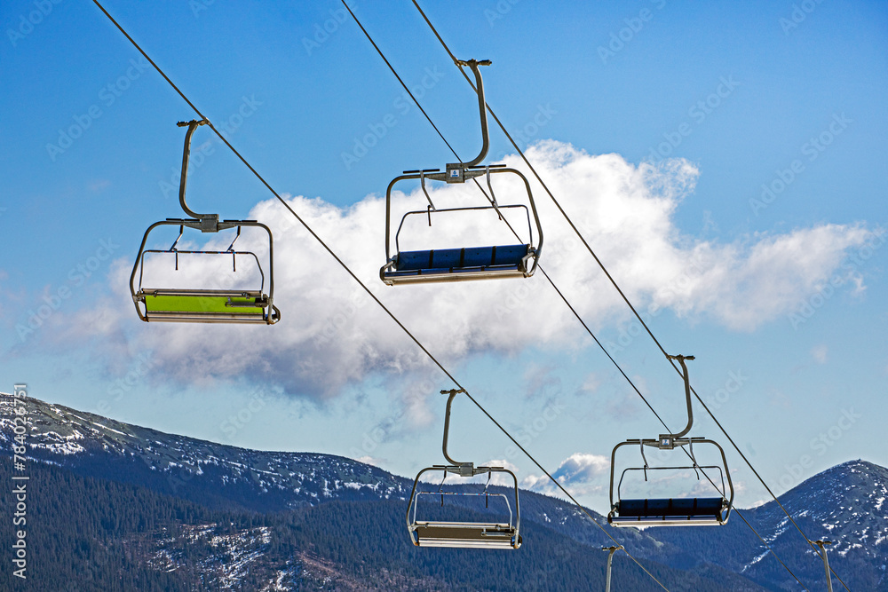 ski lifts against the background of a blue sky with clouds. Ski resort Active recreation ski lifts against the background of a blue sky with clouds. Ski resort Active recreation