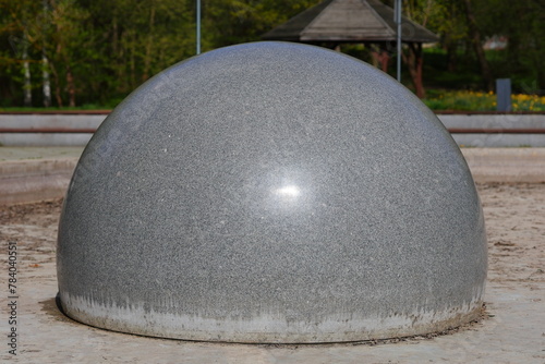Gray granite ball in the city park © andsy