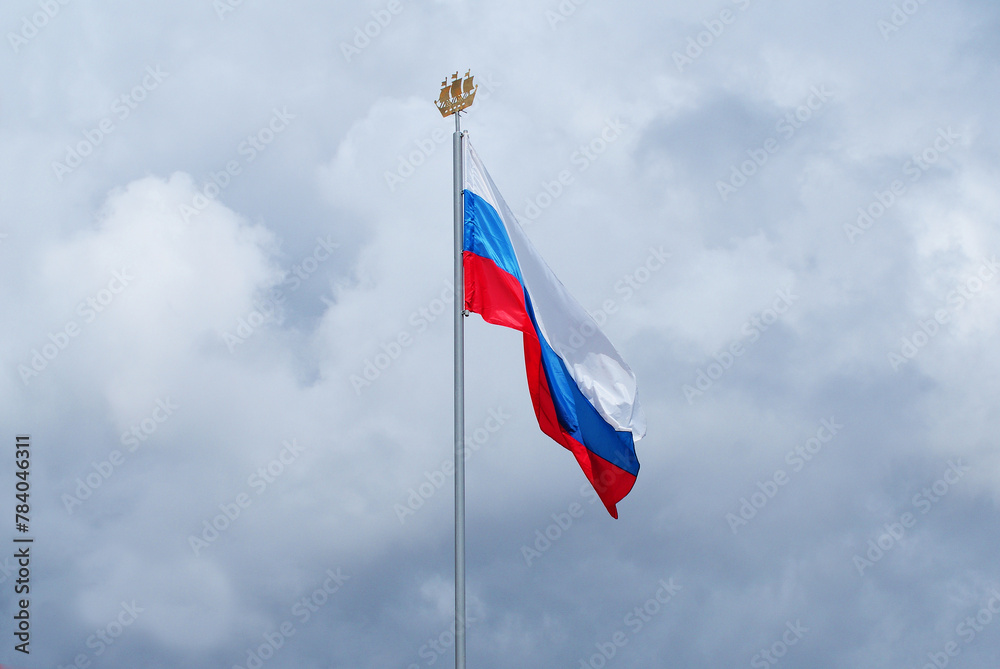 The Russian flag flutters in the wind against the blue sky, Background.