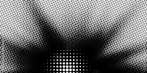 wide, black and white image featuring a rectangular border composed of a double-layer dot matrix with a diminishing dot size towards the center. photo