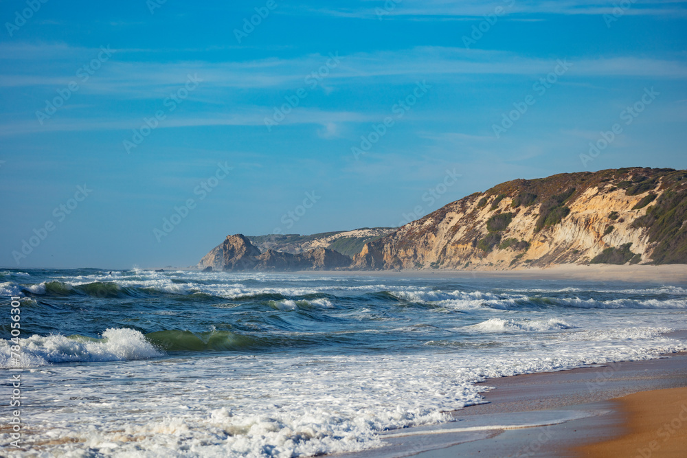 Coastal scenery with gentle surfs meeting shore steep cliffs Coastal scenery with gentle surfs meeting shore steep cliffs