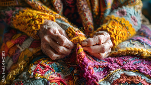 Hands of woman knitting a vintage wool quilt