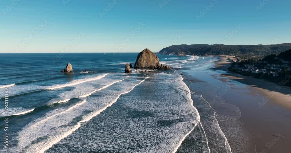 Aerial view of Haystack rock with the waves coming in on an early morning spring day