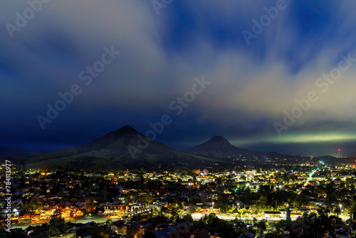 Mountain and city lights at night, clouds, 