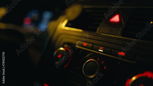 Closeup of car dashboard with AC conditioner button in ON position photo