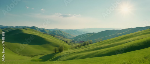 Panorama of beautiful countryside. Wonderful springtime landscape in mountains. Grassy field and rolling hills. Rural scenery