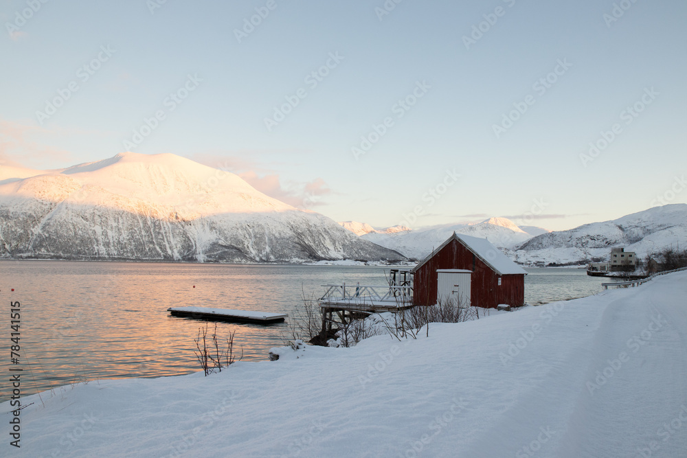 Cabin by the lake in wintertime.