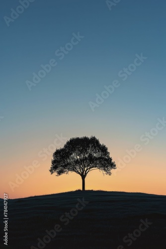The silhouette of a lone tree on a vast horizon, serving as a testament to the enduring strength found in simplicity amidst complexity. © Kanisorn
