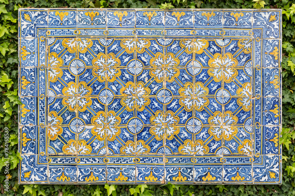 Traditional Blue and White Portuguese azulejos Tiles in a Flower Vase Design Mounted on a Garden Wall Traditional Blue and White Portuguese azulejos Tiles in a Flower Vase Design Mounted on a Garden Wall
